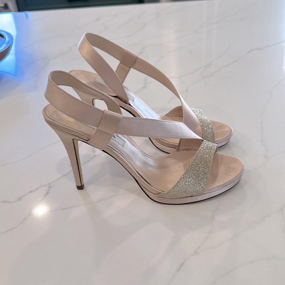 Champagne colored high heeled dressy sandals with gold glitter straps.